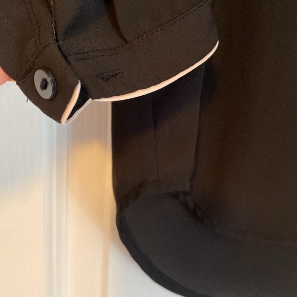 H&M black blouse with cream detailing. Front pockets. Button on sleeves. - Picture 3 of 4